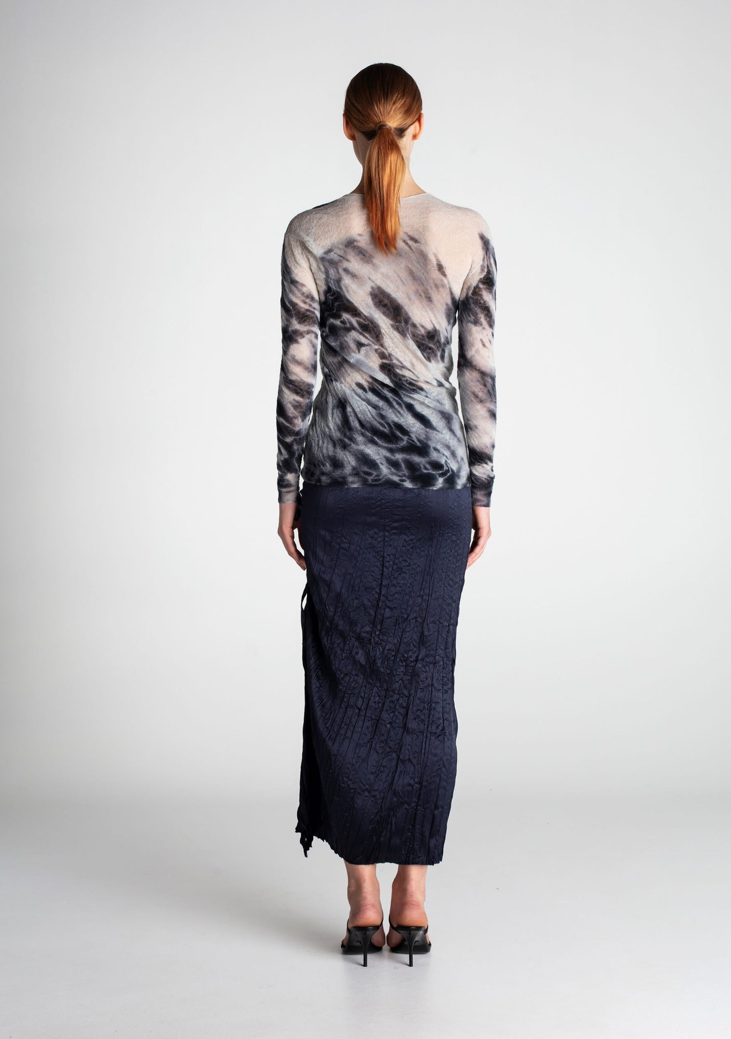 Back of wool jumper with unique Shibori-dyed pattern extending across the fabric.