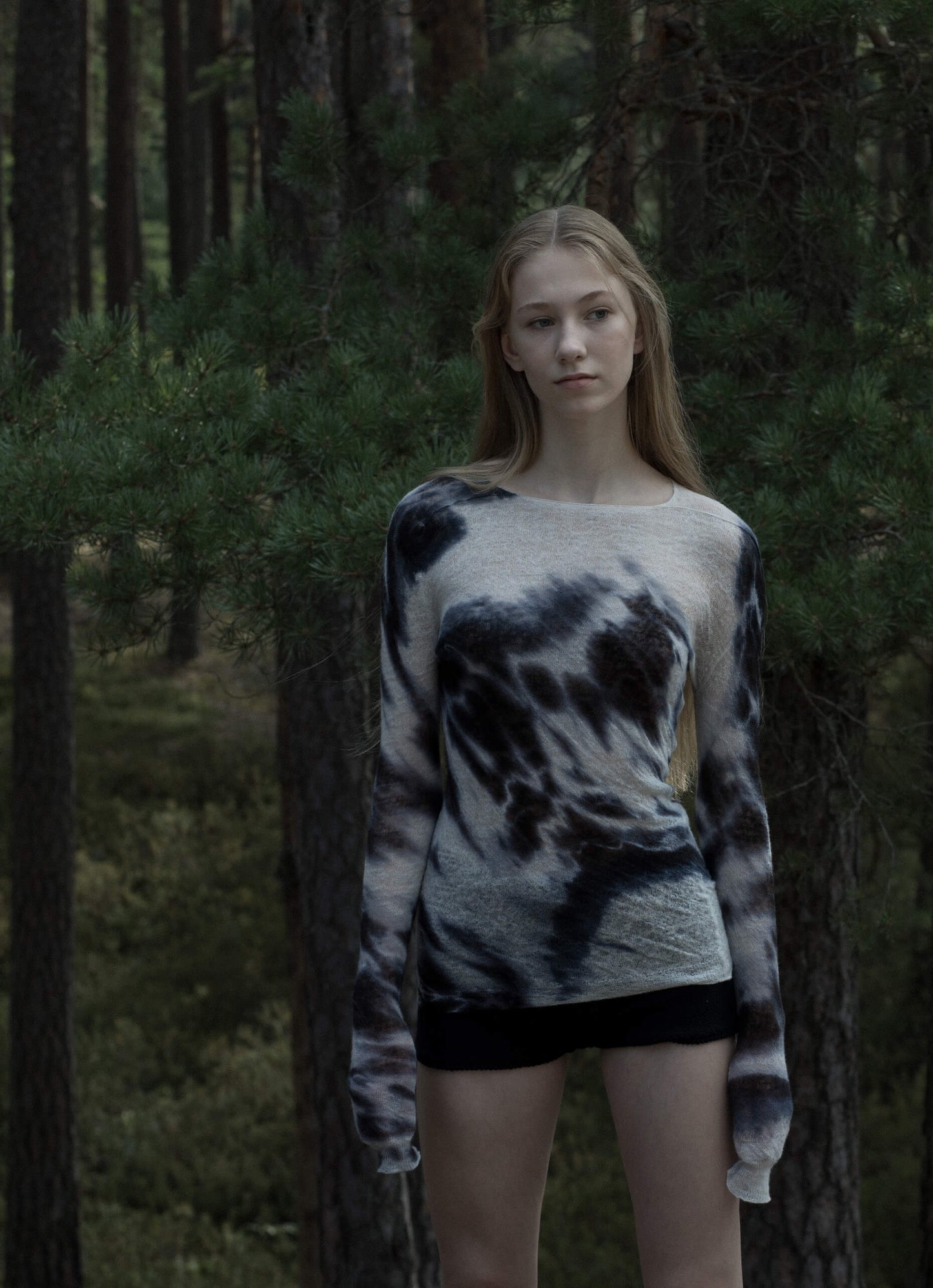 Wool jumper styled outdoors, blending with natural patterns, highlighting its lightweight drape.