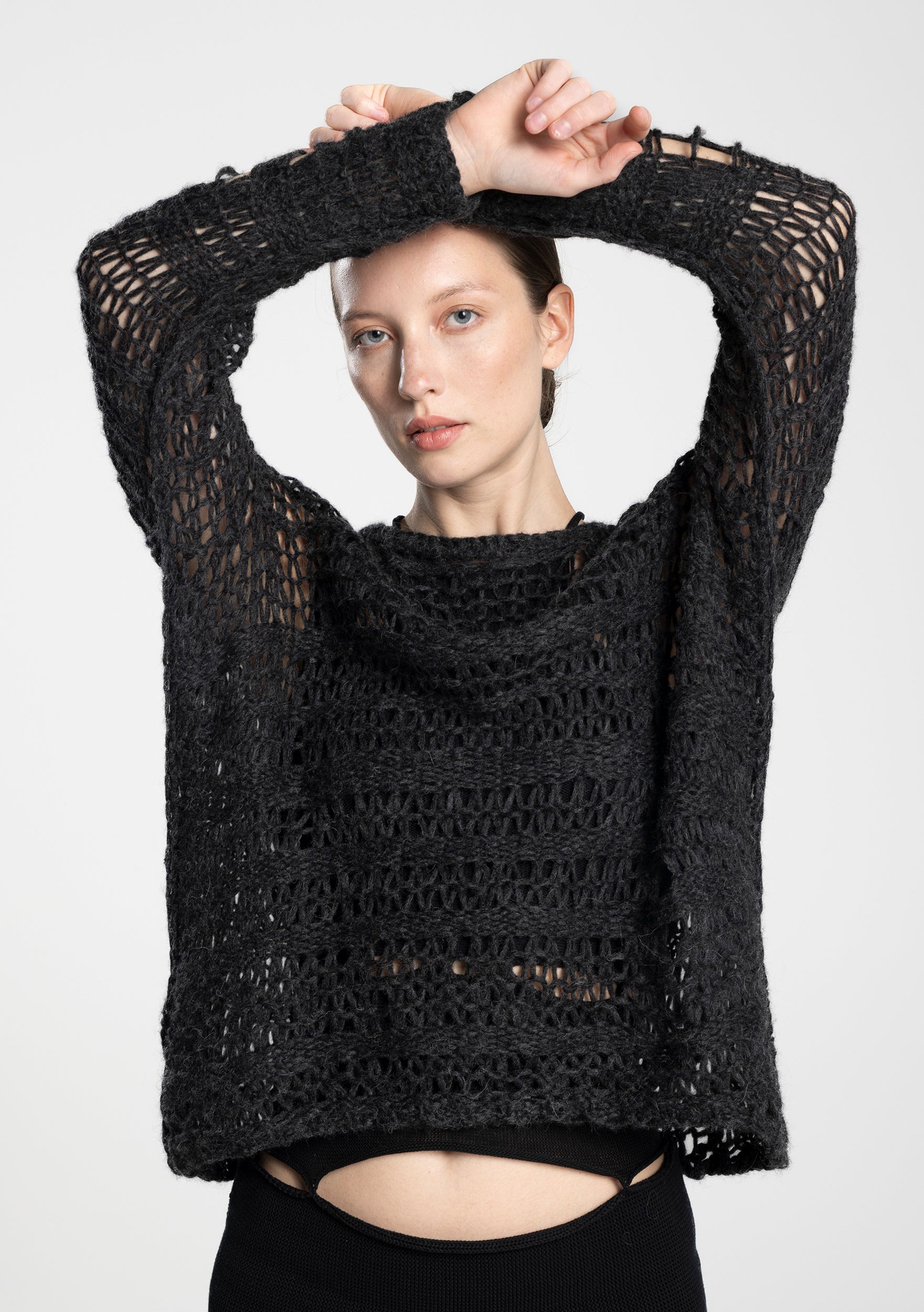 close-up of soft, open-knit alpaca pullover with a round neckline, front view.